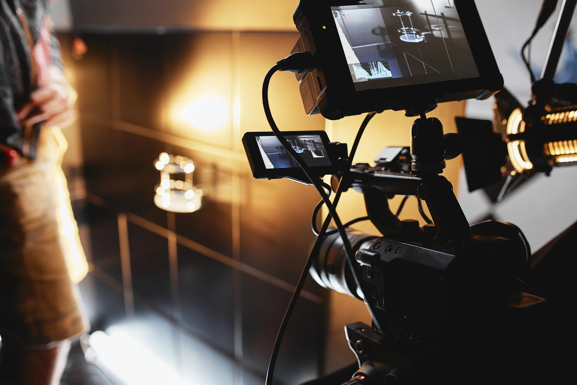 Professional video production studio with cameras, lighting rigs, and broadcast equipment set up for a shoot